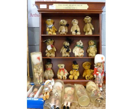 A set of twelve Danbury Mint The Teddy Bear Museum Teddy Bears with display rack and a collection of dolls 