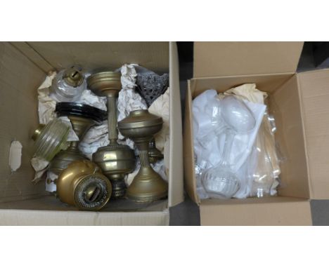 A collection of oil lamp and chimneys **PLEASE NOTE THIS LOT IS NOT ELIGIBLE FOR POSTING AND PACKING** 