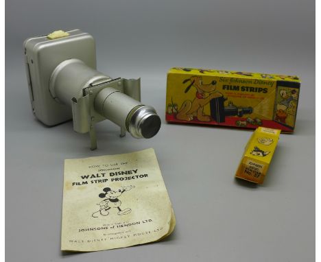 A mid 20th Century Johnson Walt Disney Film Strip Projector, a box with six Johnson Film Strips, one other film strip and an 