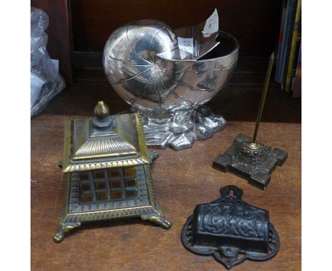 A brass inkwell, a font, a desk spike and a silver plated nautilus shaped sugar basin 