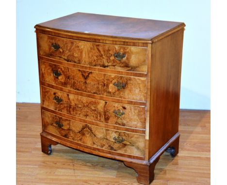 A reproduction figured walnut bow front chest of drawers, with four graduated drawers, 84cm high x 77cm wide x 46cm deep