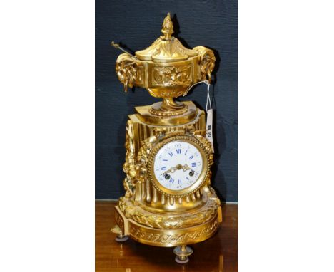 A late 19th / early 20th century French gilt metal and ormolu mantle clock, the white enamel dial with Roman and Arabic numer