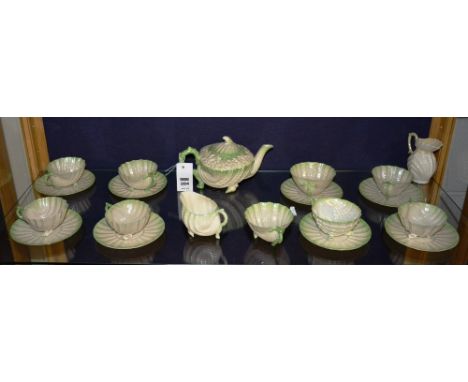 A late 19th century Belleek tea service, comprising of teapot, eight cups and saucers, cream and sugar, also with later cream