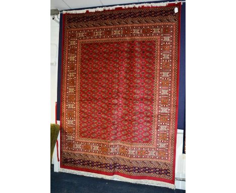 A machine made Bokhara carpet, on red ground, 280 x 200cm