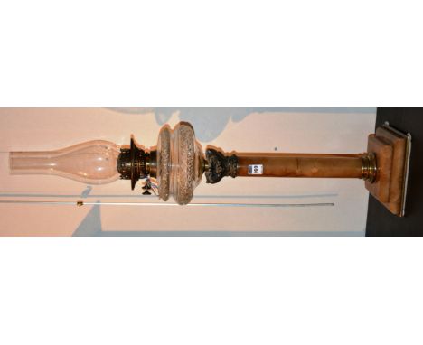 A duplex oil lamp, with glass reservoir, raised on faux marble column, 85cm high
