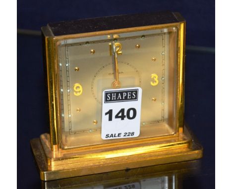 A gilt metal alarm clock inscribed Omega, with silvered dial, 9cm high CONDITION REPORT: Lot 140 - surface scratches, marks, 