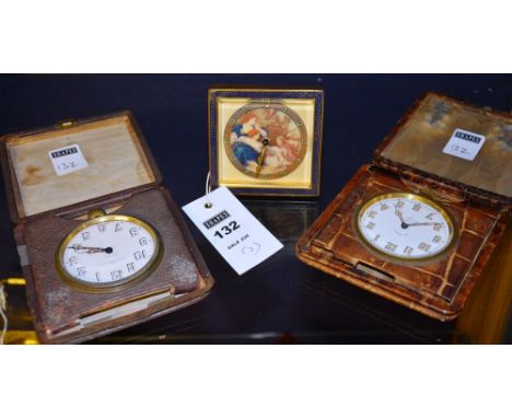 A 1930's French desk clock on easel support, 9cm high, together with two 1930's eight day Goliath travel clocks (3)