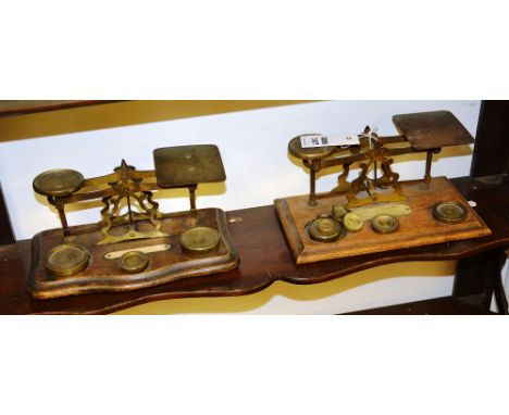Two sets of Victorian oak and brass postal scales, with assorted brass weights