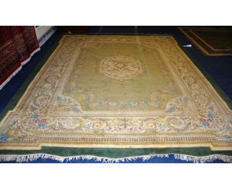 A large Indian style carpet, on cream ground with green border