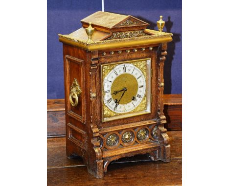 A Continental oak cased bracket clock, with Lenzkirch movement, the enamelled chapter ring with Roman numerals, decorated wit