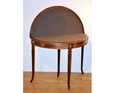 A Georgian style mahogany demi-lune fold over card table, enclosing felt interior, 73cm high, 92cm wide x 47cm deep