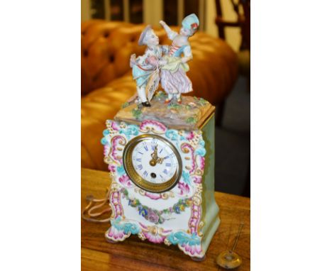 A late 19th/early 20th century Meissen style mantle clock, the white enamel dial with Roman and Arabic numerals, decorated wi