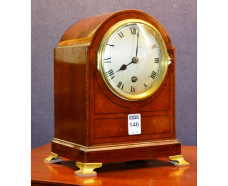 A mahogany domed and line inlaid Asprey bracket clock, with silvered dial, raised on brass feet, 25cm high