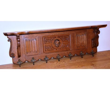 A French oak shelf, the carved panel above a line of seven coat hooks, 39cm high x 114cm wide CONDITION REPORT: Lot 480 - min