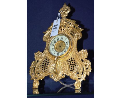A gilded metal mantle clock, on easel support decorated with birds in foliage (a/f)