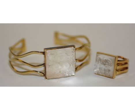A white metal Lalique bangle and ring set, both with moulded glass inserts in the form of a girls face, stamped Lalique to un
