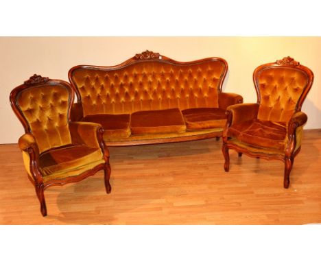 A Victorian style button back settee, with a pair of matching armchairs, upholstered in gold velour, settee 102cm high x 179c