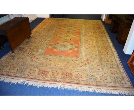 Large Turkish Milas Carpet, with three central Lozenges and geometric decoration, on fawn ground, 454cm long x 323cm wide CON