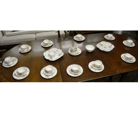 A Coalport teaset, with floral motif over white ground, consisting of cups and saucers, side plates, sugar and biscuit plates