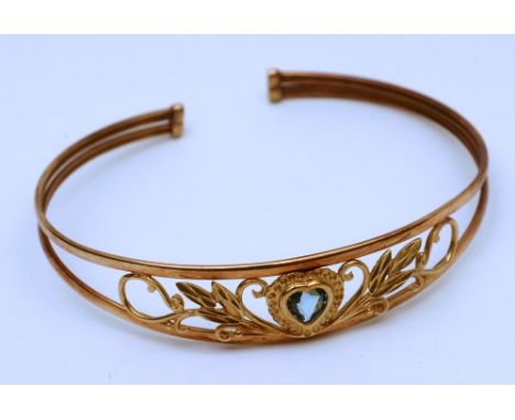 A gold and aquamarine heart bangle, the dual band set with foliate decoration and heart shaped aquamarine to centre, 6.4g