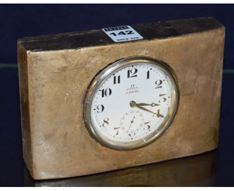 A desk clock inscribed Omega, the white enamel circular dial with Arabic numerals and subsidiary seconds dial (back lacking),