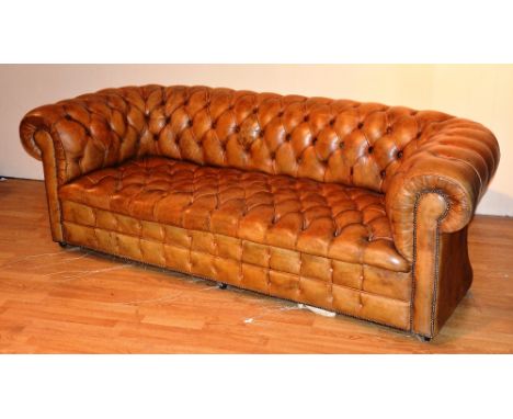 A tan leather button back Chesterfield, 76cm high x 220cm wide x 90cm deep CONDITION REPORT: Lot 624 - Lining has burst to pl