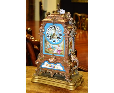 A late 19th/early 20th century French gilt metal Sevres style mantle clock, the enamel dial with Roman numerals and decorated