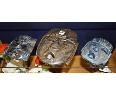 Three Mayan polished hardstone masks, 16 & 25cm high