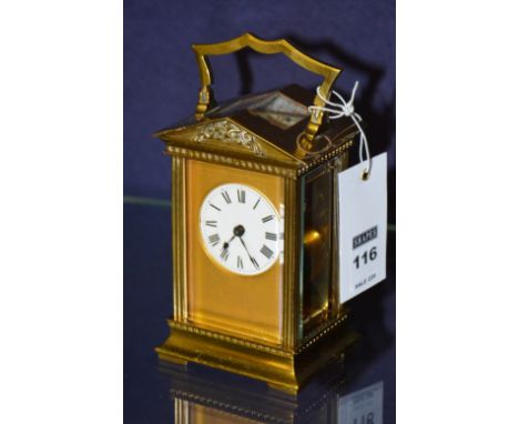 A French brass carriage clock, with white enamel dial and carry handle, 18cm high CONDITION REPORT: Lot 116 - glass panels ar