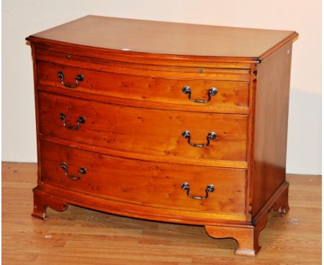 A modern yewwood bow front chest of drawers, with brushing slide above three graduated long drawers, 73cm high x 94cm wide x 