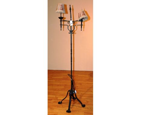 An Arts & Crafts metal floor lamp, raised on stylized supports, 160cm high