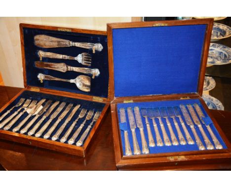 A plated six piece fish service, in fitted oak case, together with a 12 piece plated fish knife and fork service in walnut ca