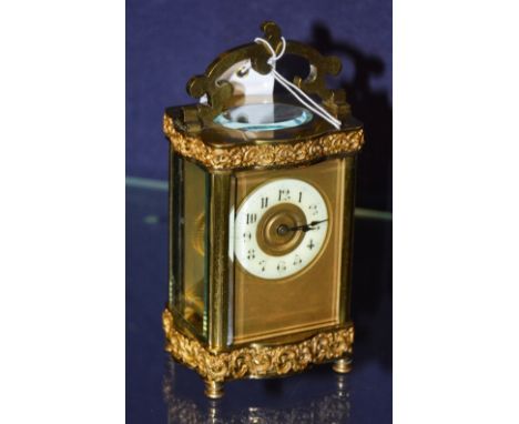 A brass carriage clock, with enamel chapter ring CONDITION REPORT: Lot 115 - Minor surface marks to filigree banding, glass p