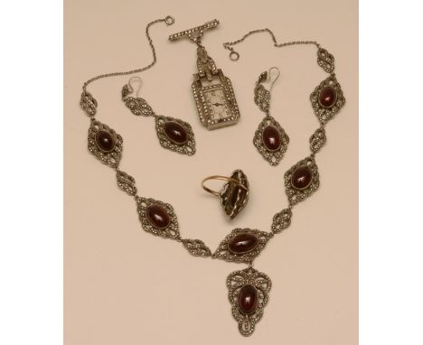 A white metal garnet and marcasite necklace, earring and ring set, the necklace set with six cabochon garnets surmounted by f
