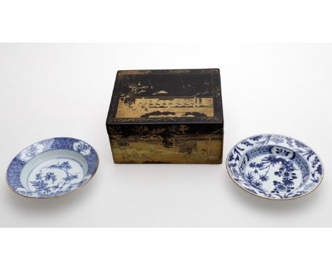 
	
		A 19th century Chinese export tea caddy, black ground with gilt landscape scenes, 20.5cms wide; and two 18th century pla