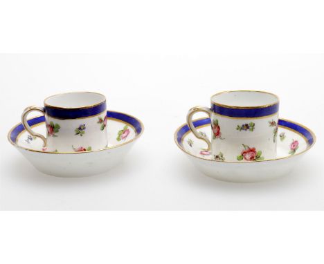 
	
		A pair of later decorated Sevres coffee cups and saucers decorated with pink roses beneath blue and gild band. The porce
