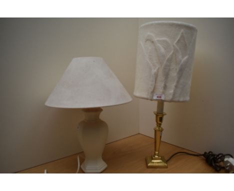 Two modern table lamps, one a ceramic hexagonal base and the other a brass candlestick style having a felt shade with stylise
