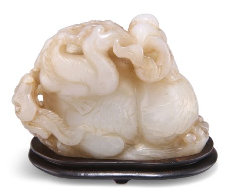 A CHINESE JADE CARVING, depicting a phoenix and young holding lingzhi fungus, to a carved wooden stand. 5cm by 9cm by 4cmCOND