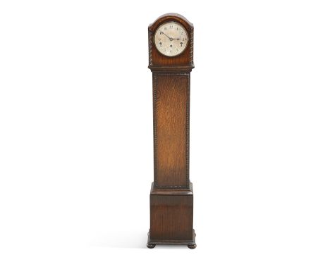 A 1920'S WARING &amp; GILLOW OAK GRANDMOTHER CLOCK, the arched top with barleytwist pilasters, three-train movement striking 