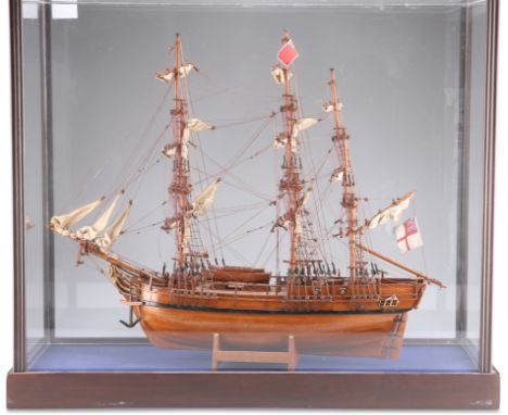 A WOODEN SCALE MODEL OF HMS BOUNTY, with deck fittings, sails and ropework, in a glazed wooden case. Case dimensions 58cm hig