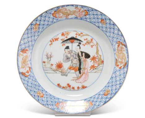 A CHINESE FAMILLE ROSE PORCELAIN DISH, the well painted and gilded depicting an elegant lady and attendant walking beneath pr