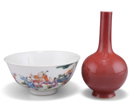 A CHINESE FAMILLE ROSE BOWL, circular, painted with boys in a garden, bears iron red four character mark, 12.5cm diameter; to