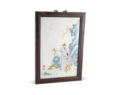 A CHINESE FAMILLE ROSE PLAQUE, rectangular, enamel painted with a man and child beside rockwork, bears two iron red seals, in