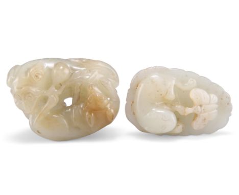 TWO CHINESE JADE CARVINGS, one depicting two dogs with a peach bough, 2.5cm by 5.5cm by 4cm; the other a cat playing with a b