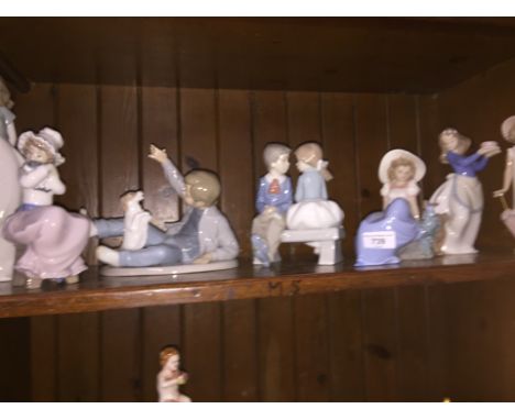 7 boxed Nao figures  Condition - five good, one damaged: girl with umbrella head been off and glued back on.