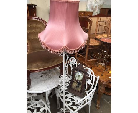 A white painted cast metal standard lamp  