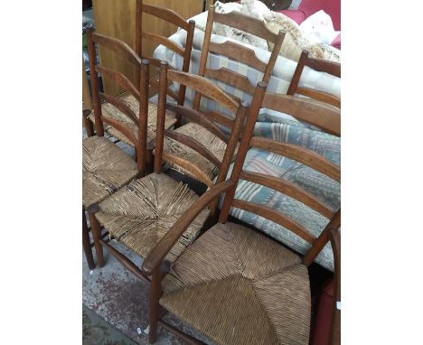 A set of five Cotswold School ladder back and rush seated chairs and another in the manner of Gimson.  