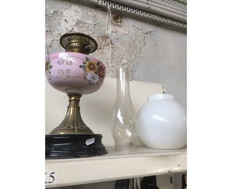 A nVictorian pink glass and brass oil lamp with funnel and shade.  Condition - general wear to include nibbles to shade rim a