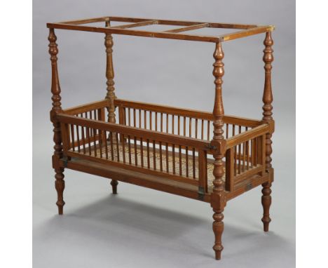 A 19th century hardwood model cot with turned supports &amp; feet, bears plaque “Made At The Boys Industrial Home Wellawatte”