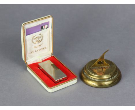 A Win cigarette lighter (cased); &amp; an M &amp; G Pensions brass “Sundial” paperweight, 2” high.